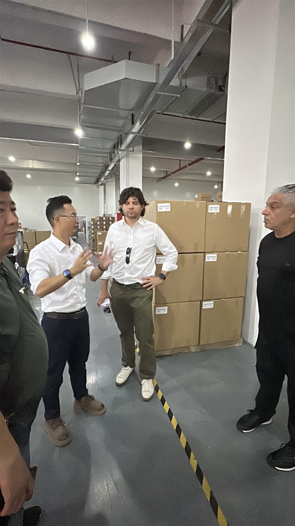 Factory-floor discussion during an overseas customer visit.